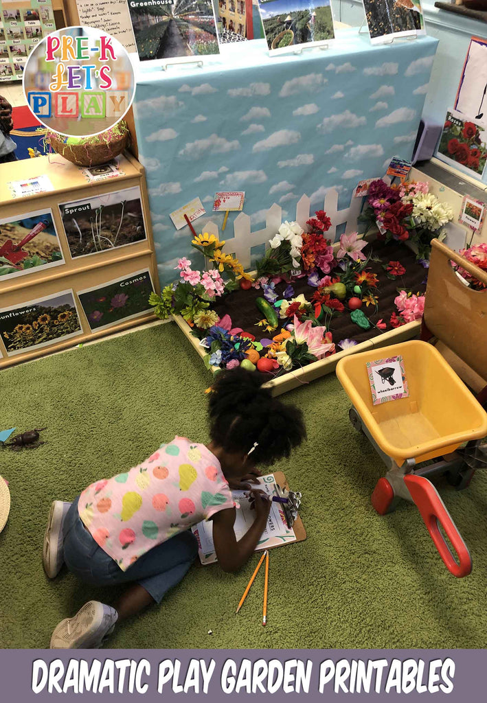 Here is a preschooler using printables to write down and draw what fruits and vegetables she plans to plant in the pretend play garden center.