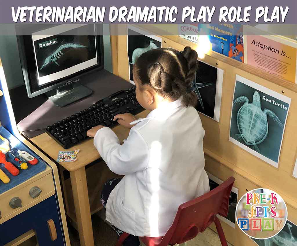 Student acting as a veterinarian for pretend play. She is looking at animal x-rays in the pet vet dramatic play clinic.