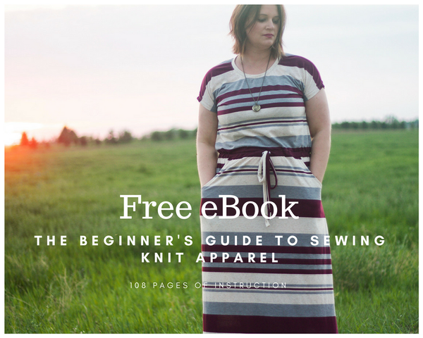 Woman wearing a striped knit maxi dress in a green field with the words Free ebook The Beginner's Guide to Sewing Knit Apparel
