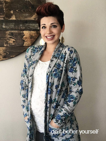 Woman wearing a white shite and a blue and gray cardigan made with french terry.