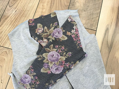 Babe Hoodie from dark floral knit sleeves right sides out laying over bodice with wrong sides out.