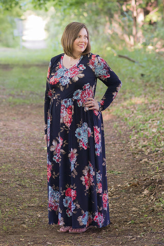 Emmeline in plus size featuring a v-neck, long sleeves, and maxi-length skirt.