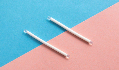 2 contraceptive implants on pink and blue background