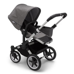 Bugaboo Donkey 3 Mono (Grey Melange/Aluminium) - quarter view, showing the pushchair in parent-facing mode with the side luggage basket