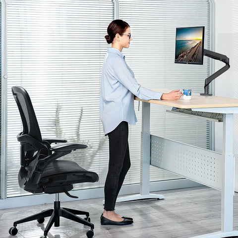 Person standing using a standing desk