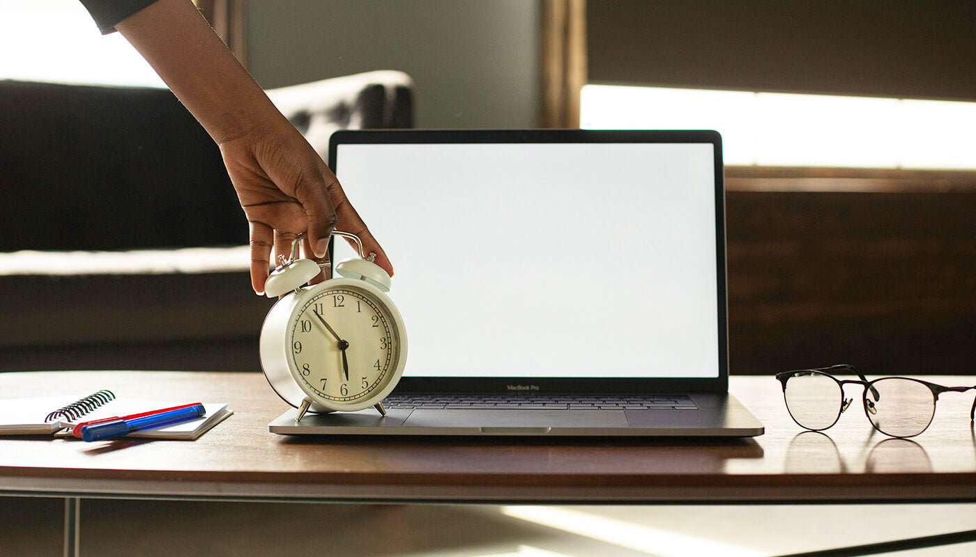 alarm clock on desk set for standing break reminders