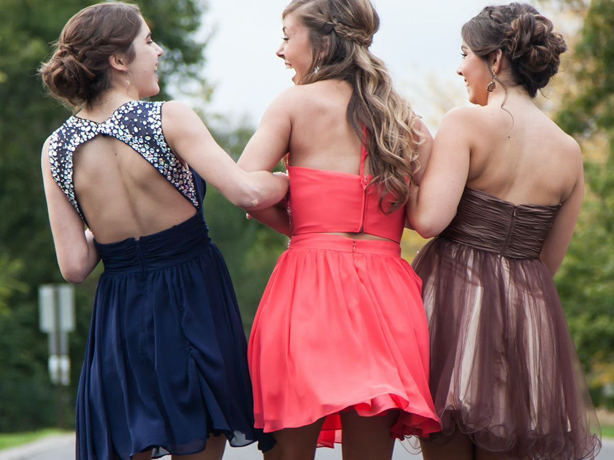 Three wedding guests in colorful dresses. 