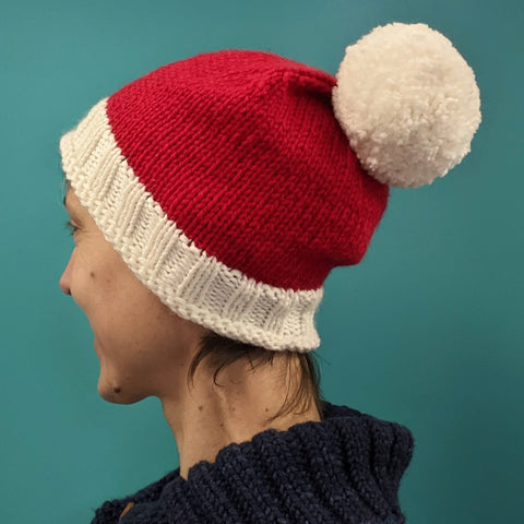 Person wearing a red and white hand knitted hat