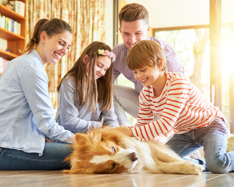 Family with new dog sitting on floor