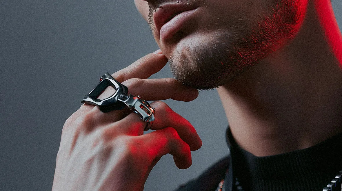 a man with cyberpunk jewelry on the fingers