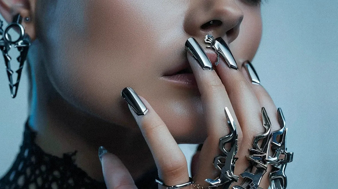 a hand of a woman with cyberpunk jewelry