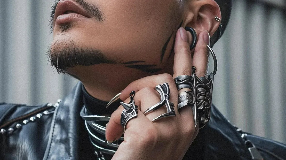 a man with cyberpunk jewelry on the hand