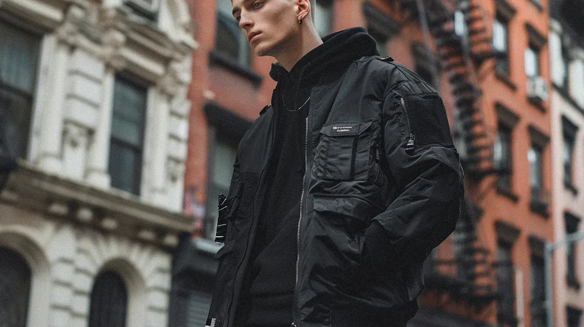 The photo captures a moment of urban fashion, with the man in a black bomber jacket taking center stage.