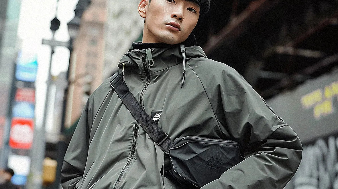 an asian man with techwear jacket wearing a techwear fanny pack