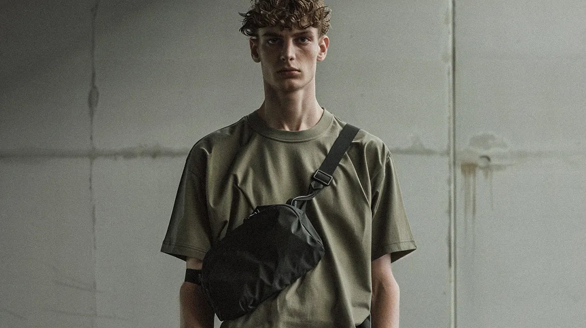 a young man wearing a techwear fanny pack