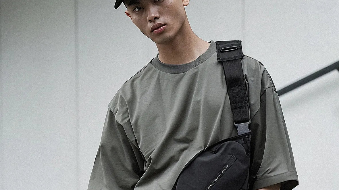 an asian man wearing a techwear fanny pack