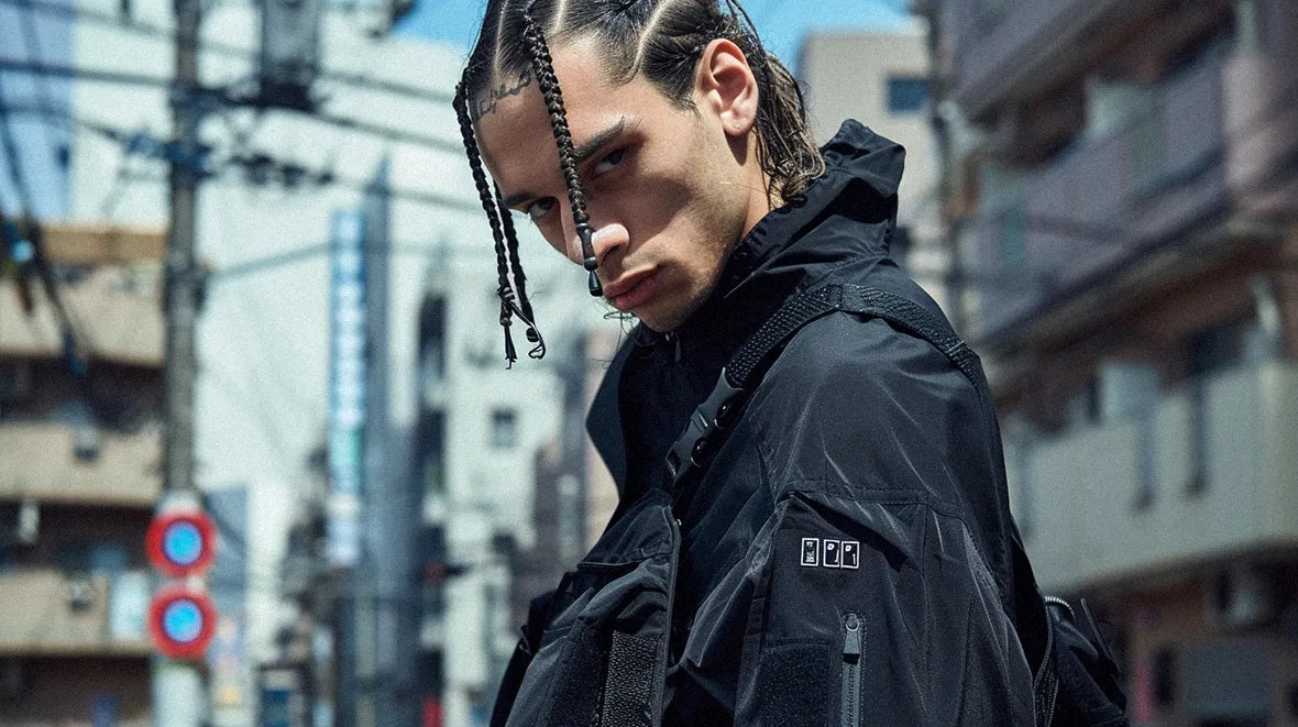 man with braids in techwear outfit