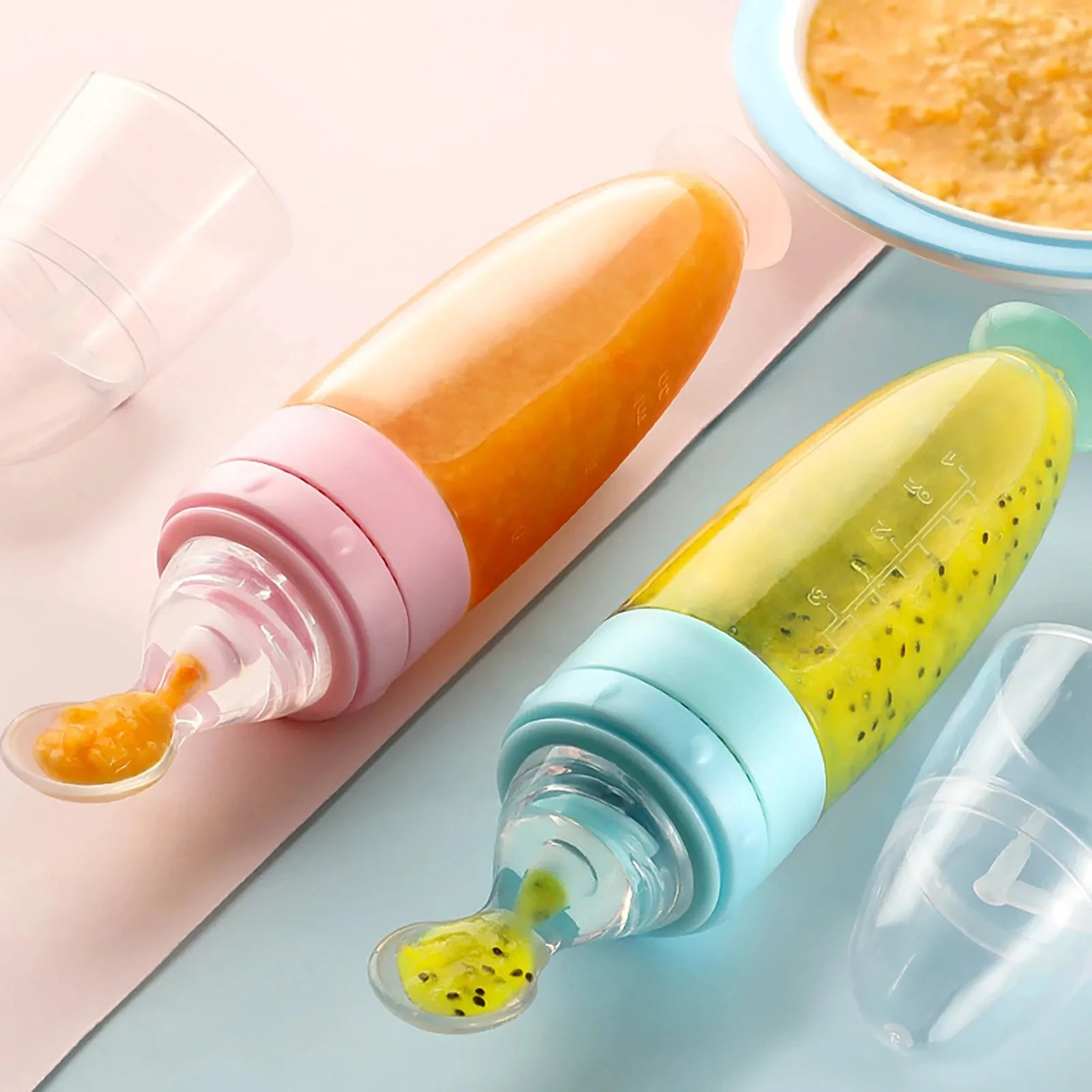 Silicone squeeze feeding spoon bottle in multiple colors.