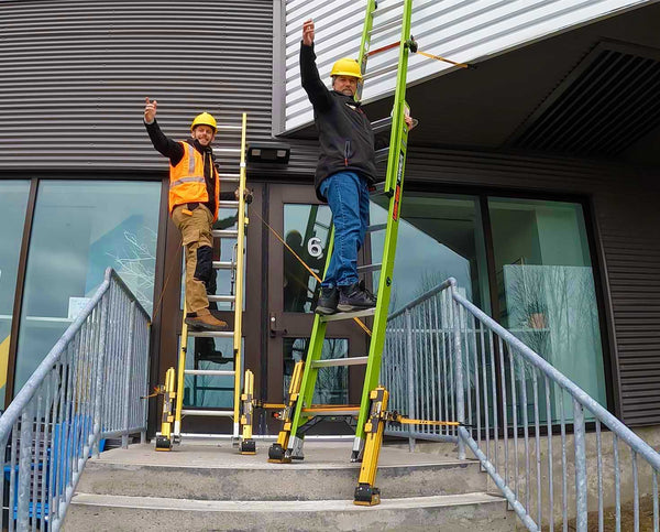 Jordan and Dale on a ladder that's being leveled, stabilized and anchored