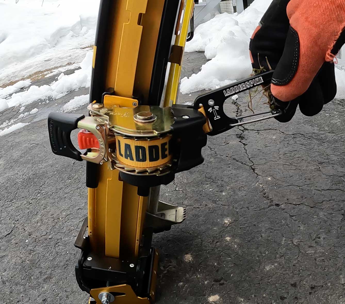 person holding ratchet with strap and carabiner