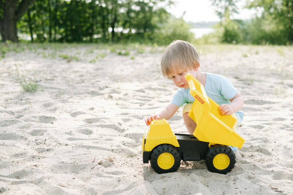 child playing with plastic excavator