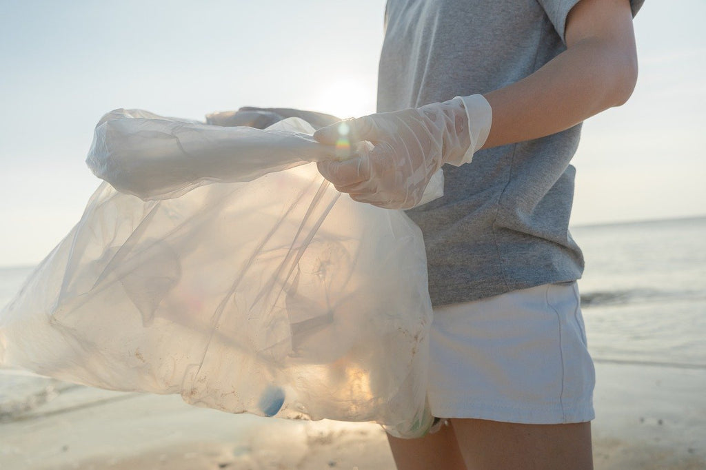 Volunteer collecting plastic on beach