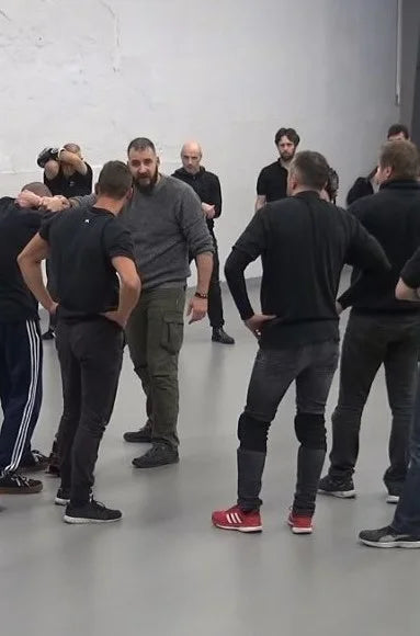 Julien in the middle of a group in France teaching a seminar