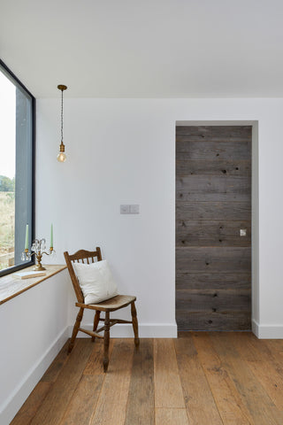 Reclaimed wood flooring used in the hallway of a modern home