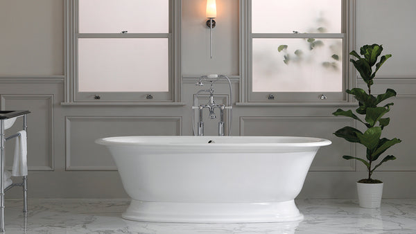 Freestanding roll top bath in a wood panelled bathroom