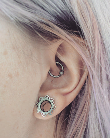 Daith piercing with a captive bead hoop earring.