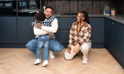 family in the kitchen with herringbone laminate flooring