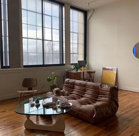 brown leather toga sofa in minimalistic with dark wood floor