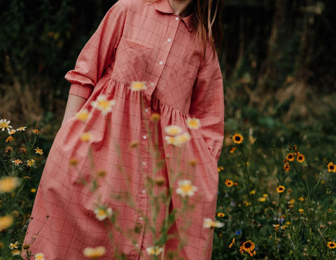 Withnell  Button through shirt dress in coral pink check. Real shell buttons.   Large patch pockets and side seam pockets. Sleeves are 3/4 length.