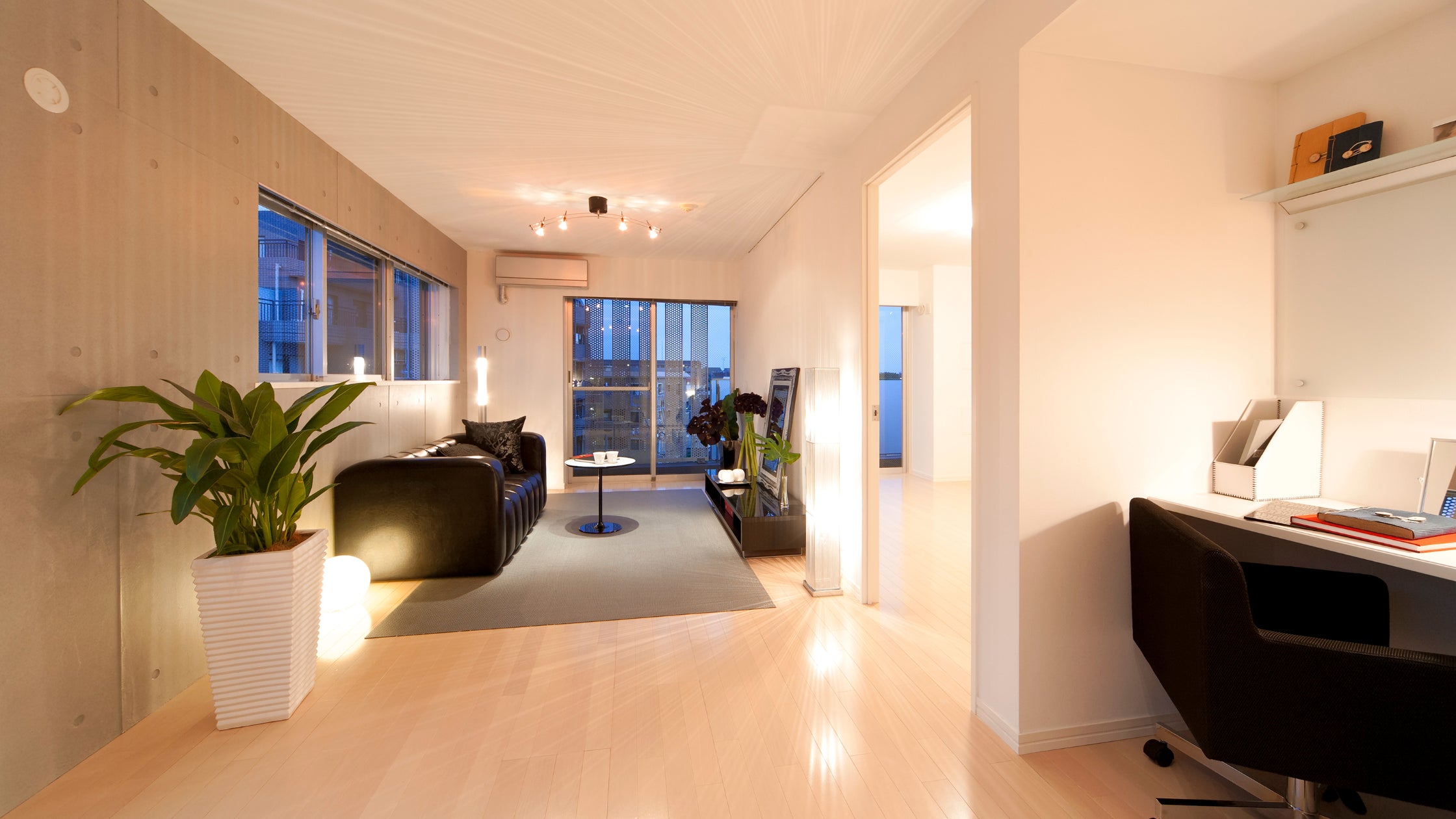 Japanese-inspired room with an open layout, minimalist design, natural wood, and a serene ambiance for a spacious and tranquil feel.