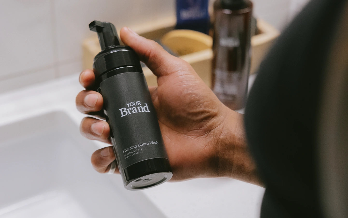 Private label hair care product being held by a person