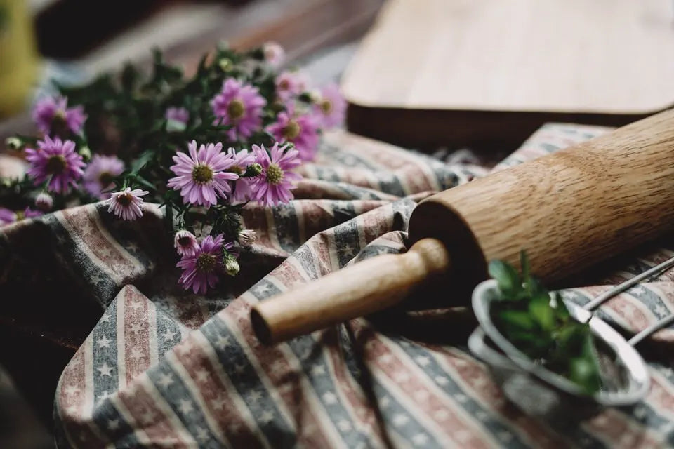 Flowers and rolling pin on a bench