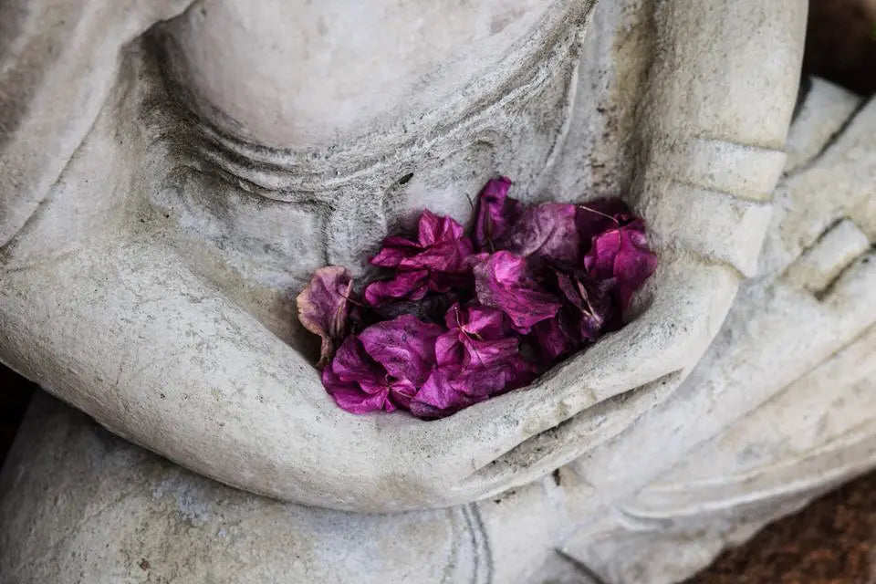 Buddha statute holding flowers