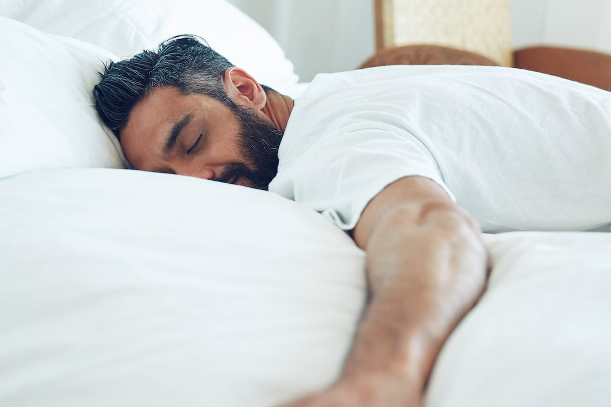 Why is REM sleep important? Man sleeping in bed.