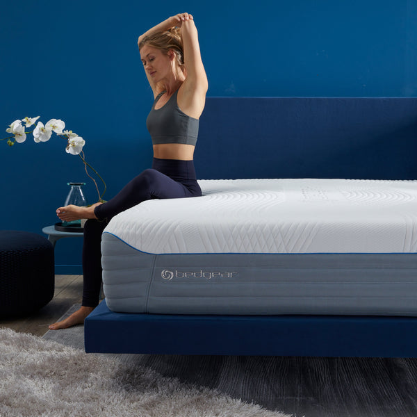 Woman Sitting On Bedgear H6 Plush Hybrid Performance Mattress