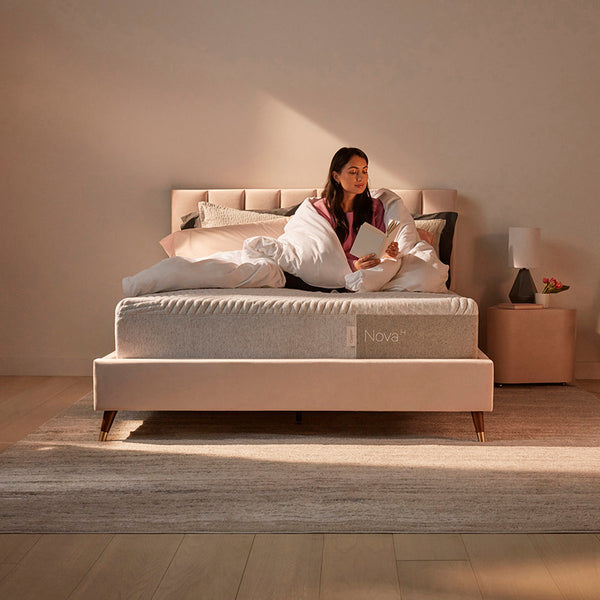 Woman Relaxing On Casper Nova Hybrid Mattress On Bed In Bedroom