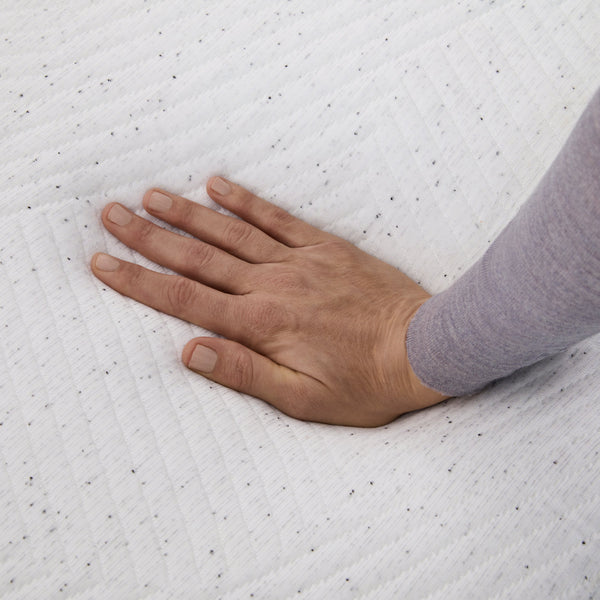 Hand pressing on Casper Snow Mattress