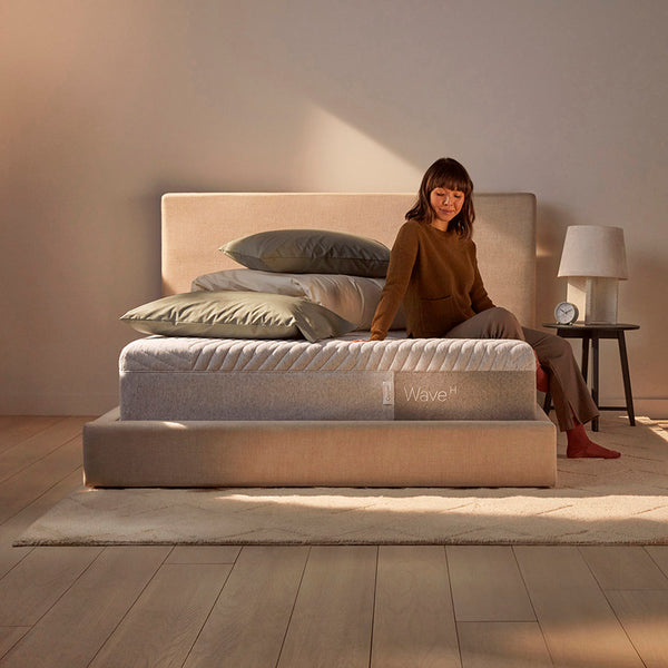 Woman Relaxing On Casper Wave Hybrid Mattress On Bed In Bedroom