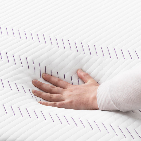 Hand Sweeping Over The Purple Hybrid Premier 4 Mattress Fabric Cover
