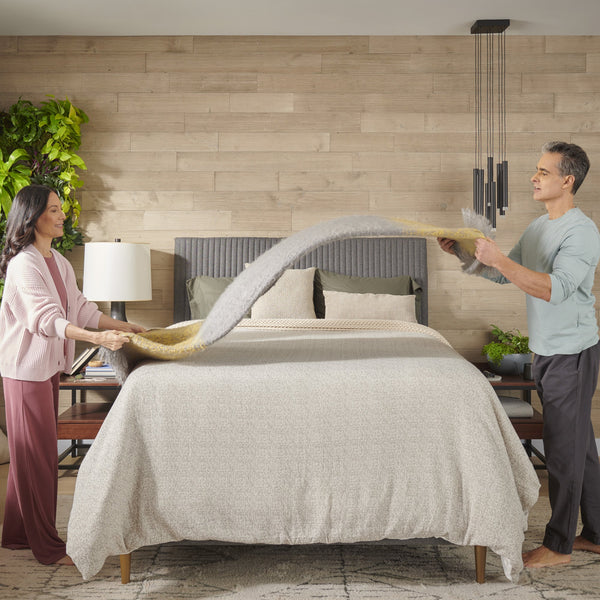 Stearns & Foster Lux Estate Medium Mattress lifestyle image of couple making bed
