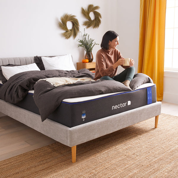 Woman Sitting On Nectar Classic 4.0 Mattress