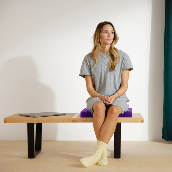 Woman Sitting On The Purple Grid Used In The Purple Double Seat Cushion On A Bench