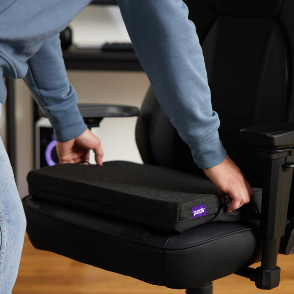 Man Placing The Purple Double Seat Cushion On An Office Chair