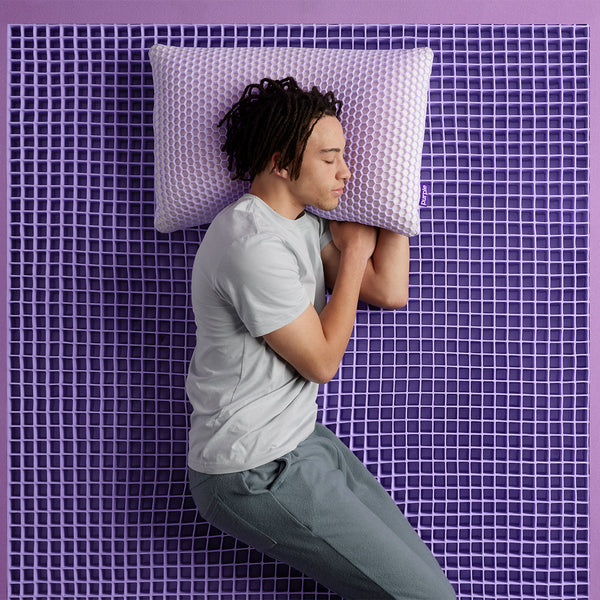 Man Sleeping On The Purple Hybrid Premier 4 Mattress Foam Grid