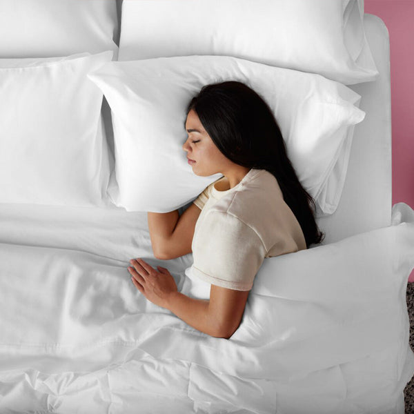 Woman Sleeping On A Purple TwinCloud Pillow In Bed