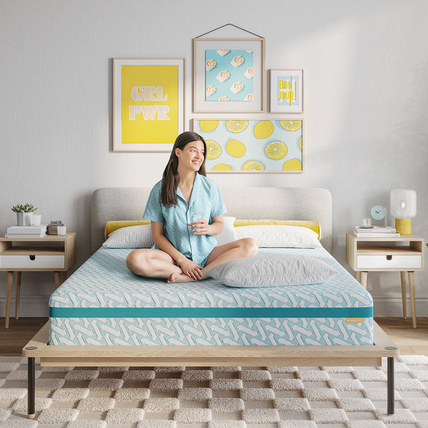 Girl sitting on Simmons Blue Dream Medium Memory Foam Mattress